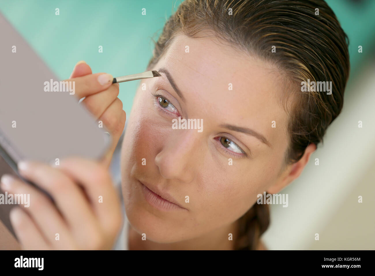 Woman applying makeup sur ses sourcils Banque D'Images