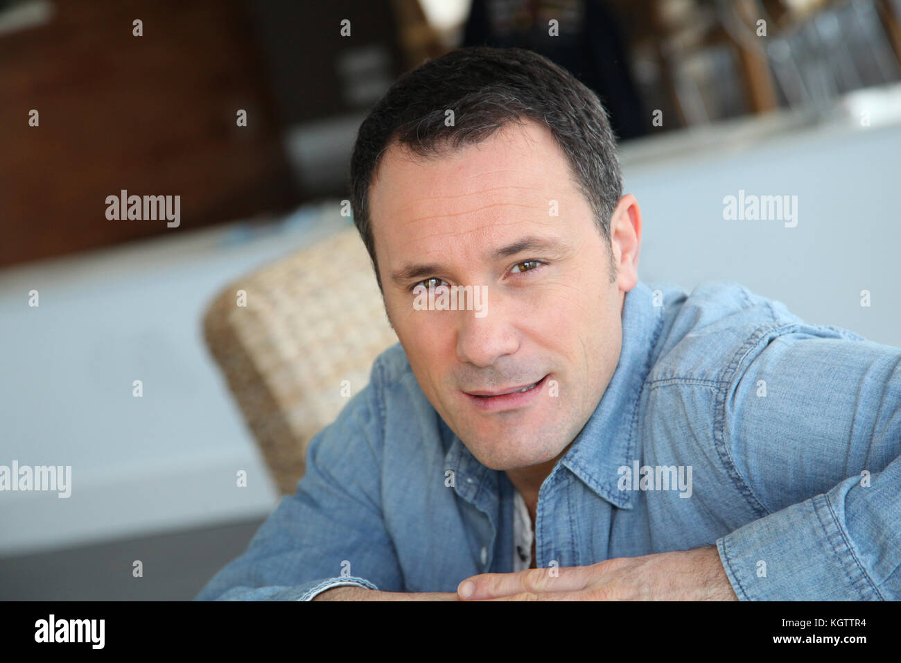 Portrait de l'homme assis dans la salle de séjour Banque D'Images