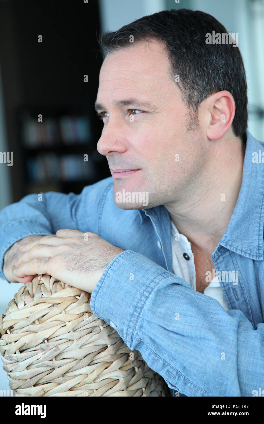 Portrait de l'homme assis dans la salle de séjour Banque D'Images