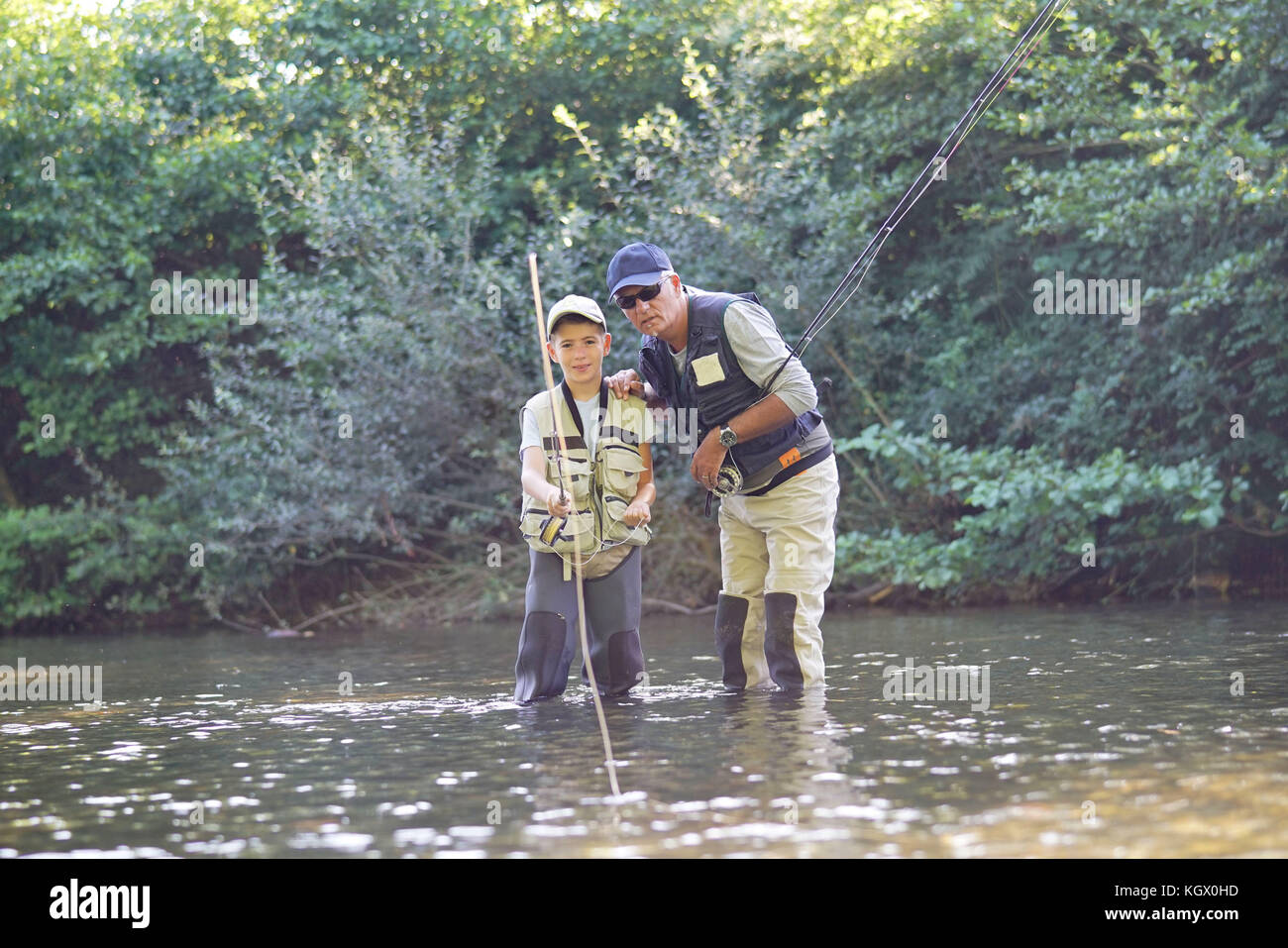 L'enseignement du père fils comment voler-pêche en rivière Banque D'Images
