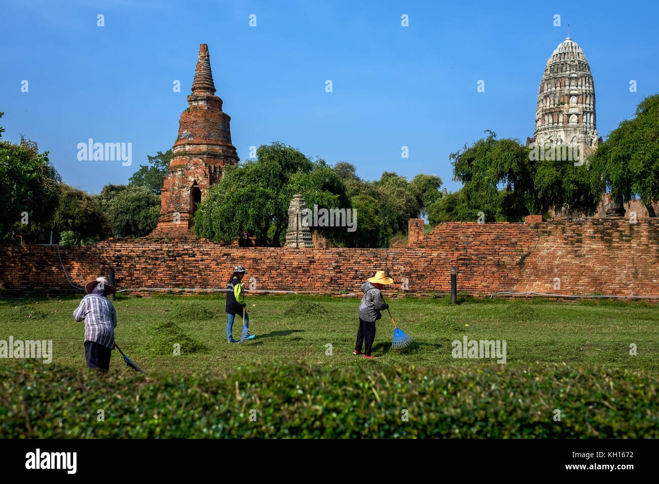 AYUTTHAYA, THAÏLANDE - 31 octobre 2017 : Wat Phra Si Sanphet temple dans le parc historique d'Ayutthaya. Nettoyer les travailleurs le territoire du parc et de tondre le g Banque D'Images