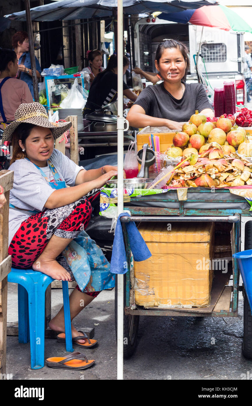 Les femmes sur l'étal de fruits mobile vente de grenades, Bangkok, Thaïlande Banque D'Images