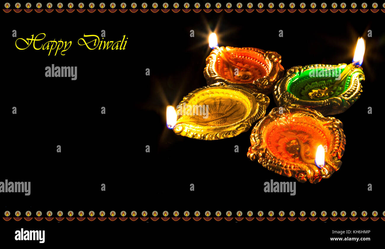 Gravure couleur diwali lampes diya argile isolé en arrière-plan foncé avec de l'espace pour le contenu des messages d'accueil Banque D'Images
