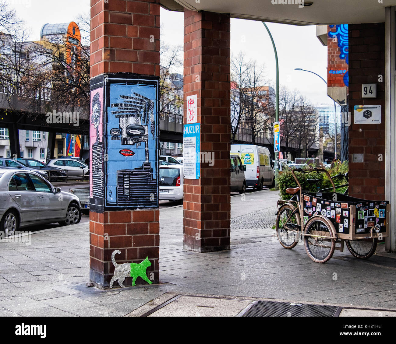 Berlin-Schönebergt.Huzur Neighborhood lieu de rencontre pour les personnes âgées.entrée colorée avec l'art de rue portrait abstrait par ALO,glass cat & tricycle Banque D'Images