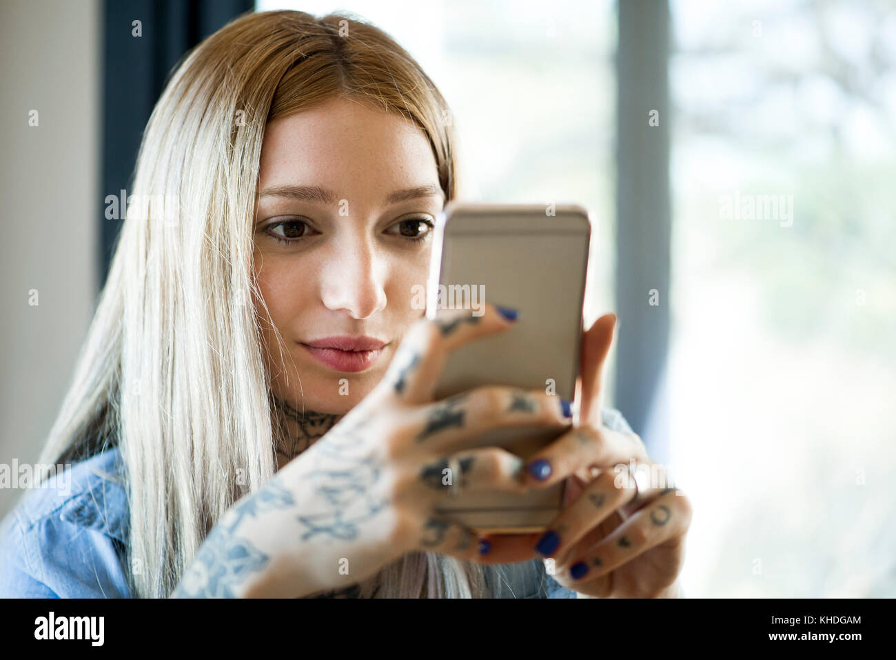 Woman looking at smartphone and smiling Banque D'Images