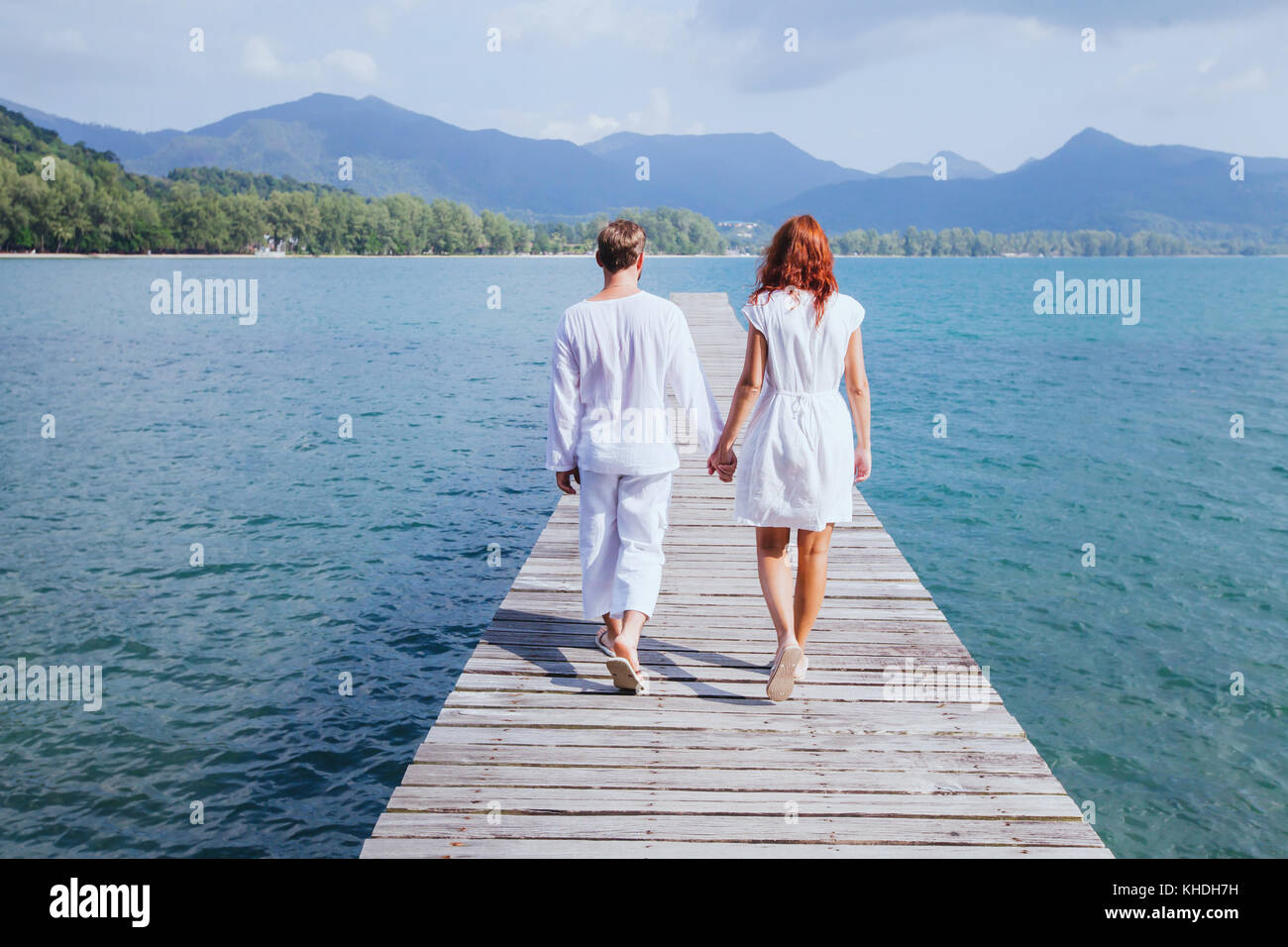 Couple en train de marcher sur la jetée en bois sur la plage, belle arrière-plan de voyage de noces Banque D'Images