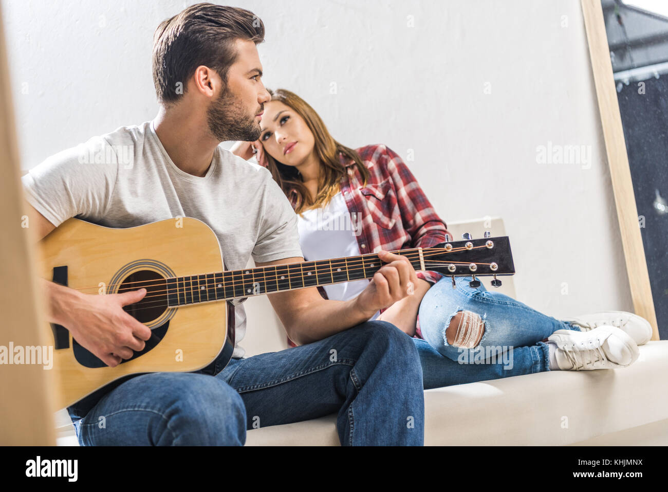 Couple on sofa with guitar Banque D'Images