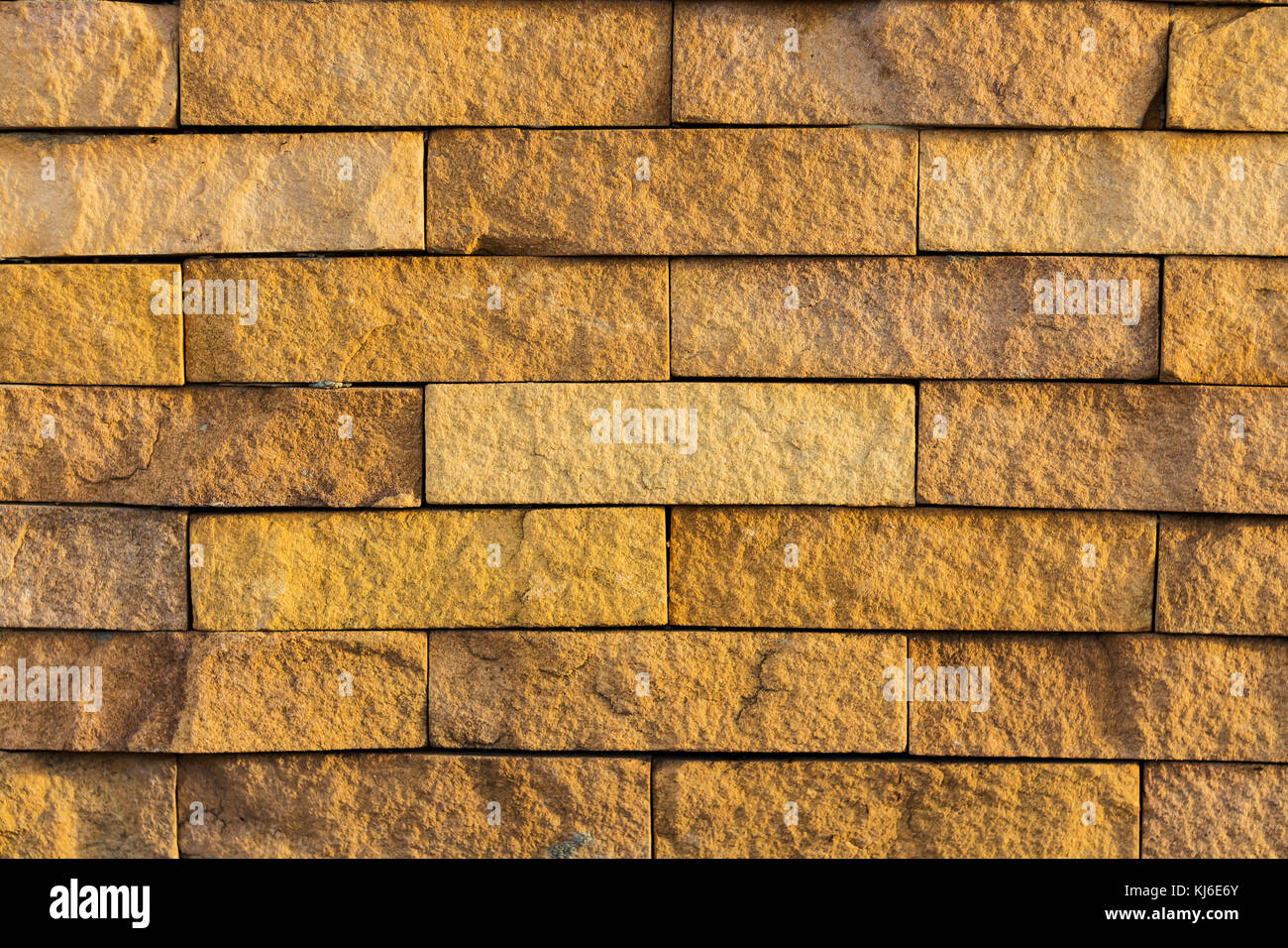 Mur de blocs de latérite de couleur orange style rétro texture Banque D'Images