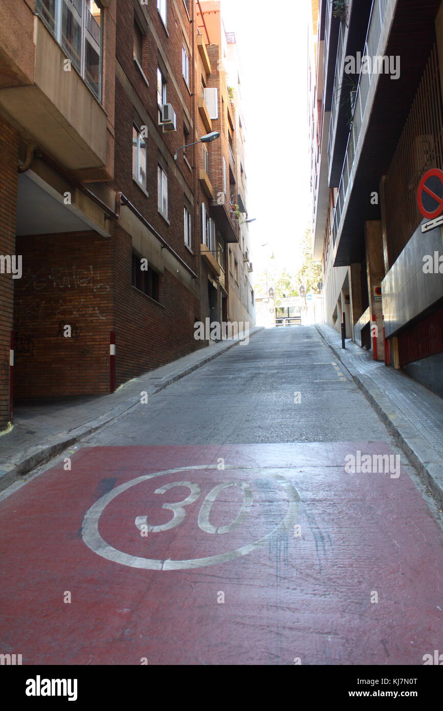 30 vitesse limite signer sur le béton dans une petite rue catalan. Banque D'Images