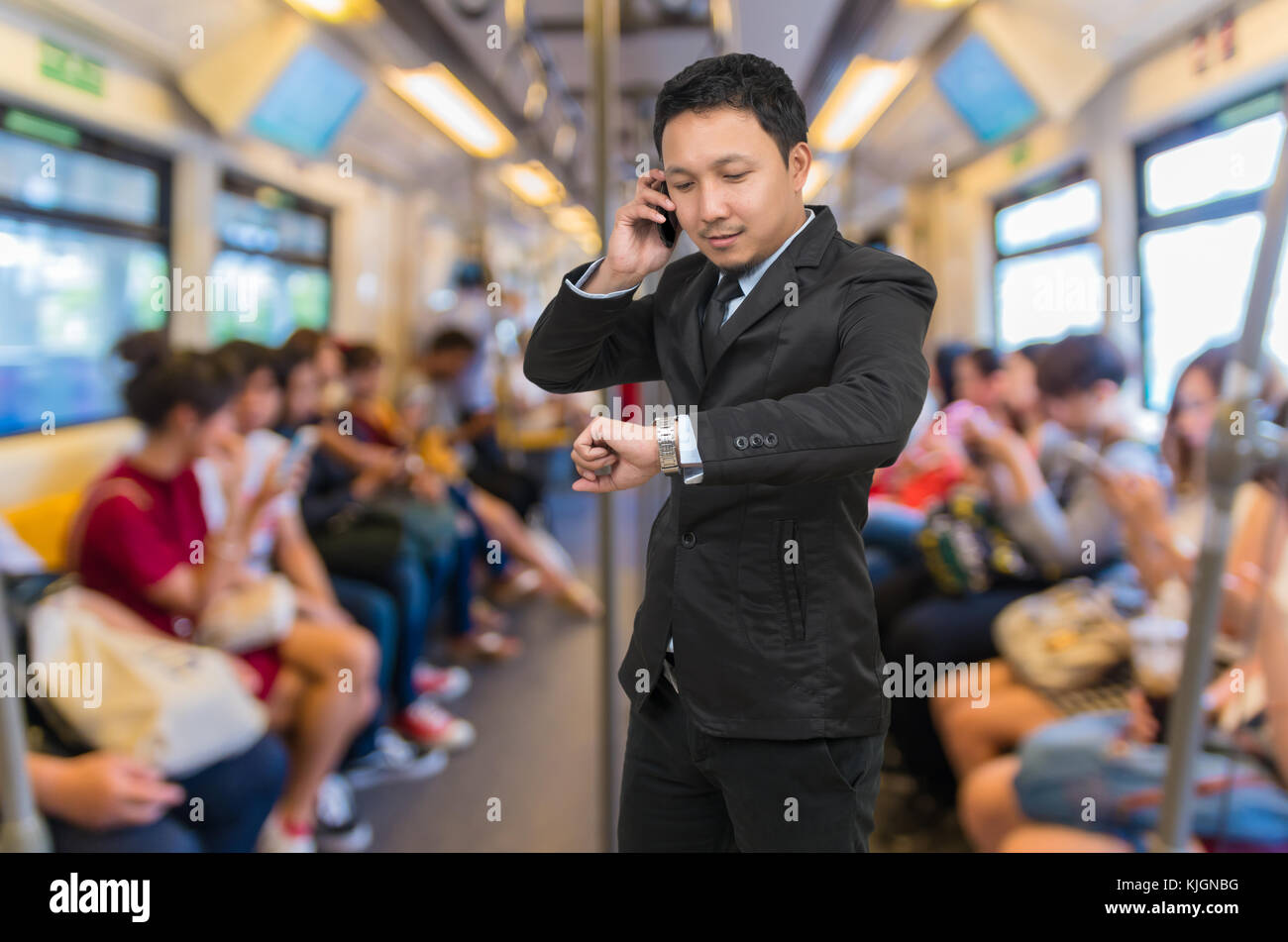 Asian businessman calling téléphone sur le flou abstrait photo de passagers qui utilisent le téléphone intelligent ou tablette en sky train, les te Banque D'Images