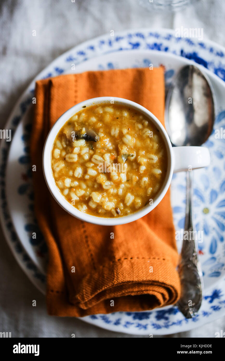 Citrouille, aux champignons et à l'orge soupe dans un bol blanc sur une table en bois. Banque D'Images