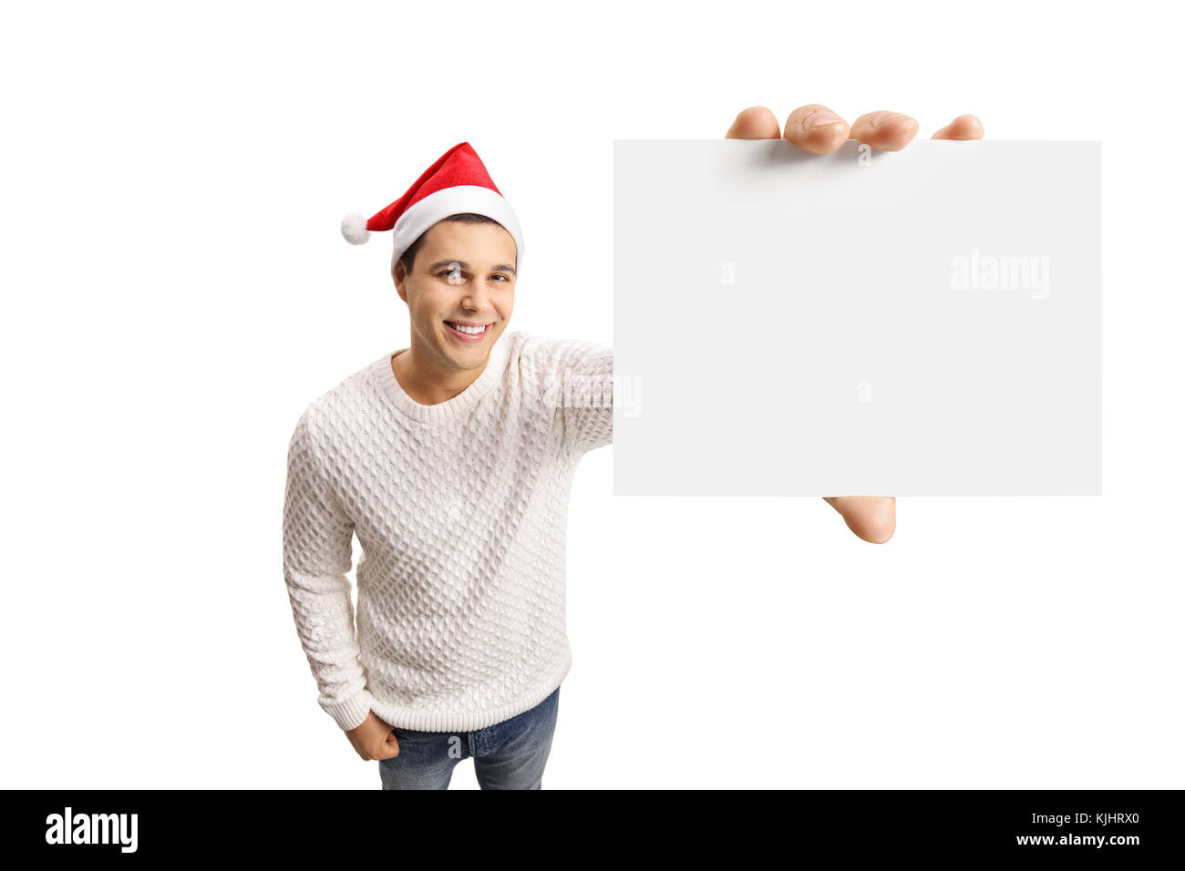 Les jeunes gars avec un chapeau de Noël montrant une carte vierge isolé sur fond blanc Banque D'Images