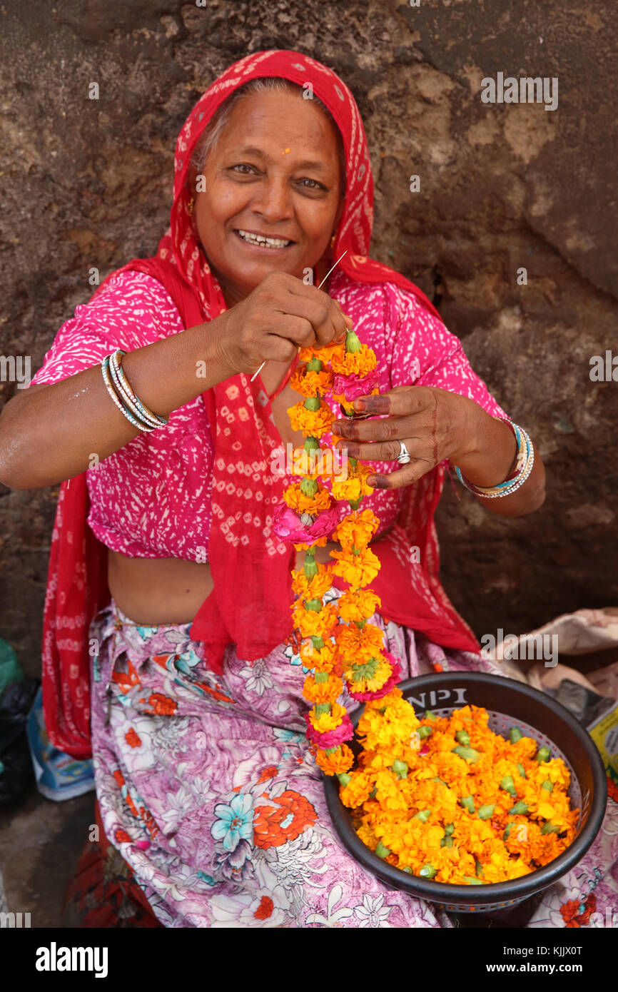 Indian woman making guirlandes dans Ajmer, Inde. Banque D'Images