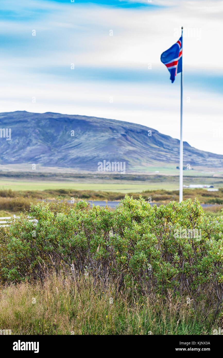 Voyager en Islande - drapeau islandais près de kerid lake en septembre soir Banque D'Images