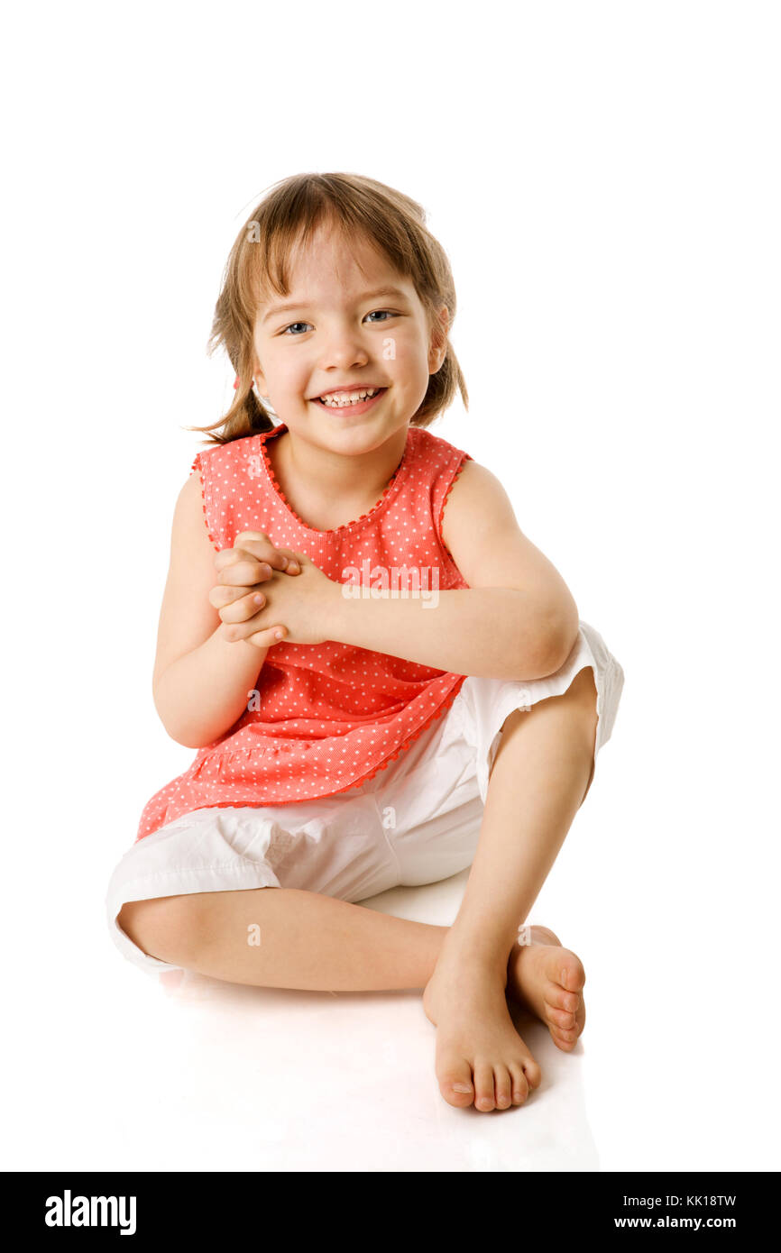 Happy Little girl sitting isolated on white Banque D'Images