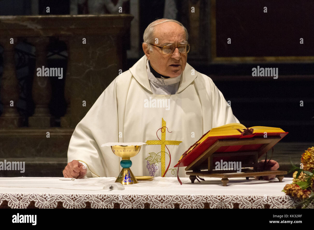 Pavie, Italie. Novembre 11 2017. Un prêtre célébrant une messe sainte à Duomo di Pavie (cathédrale de Pavie). Il prie sur le pain et le vin sur l'alt Banque D'Images
