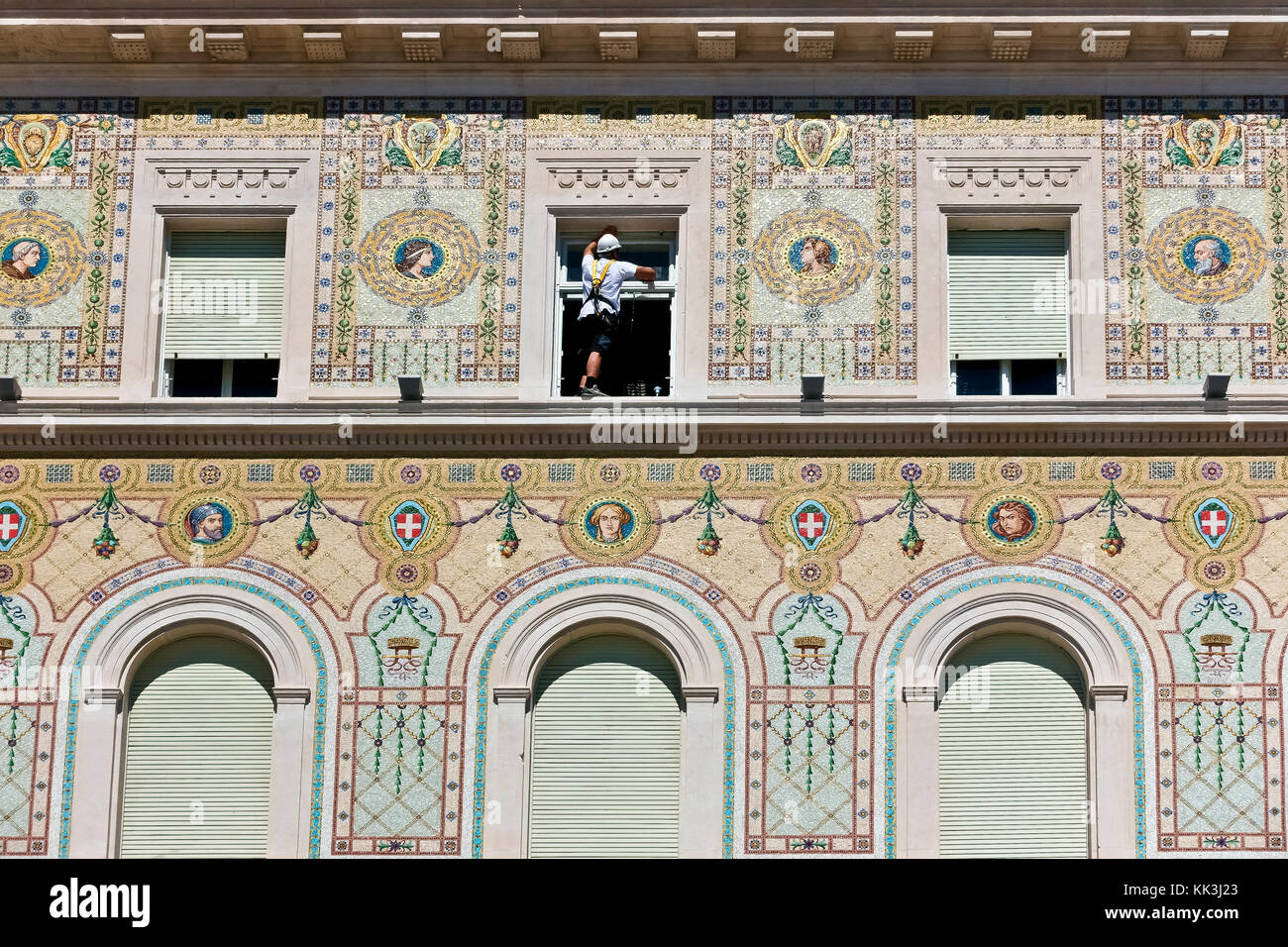 Workman portant un harnais, nettoyant les lunettes de fenêtre. Travail dangereux. Bâtiment du gouvernement, Unity Square. Palazzo del Governo.Trieste, Italie, Europe, UE Banque D'Images