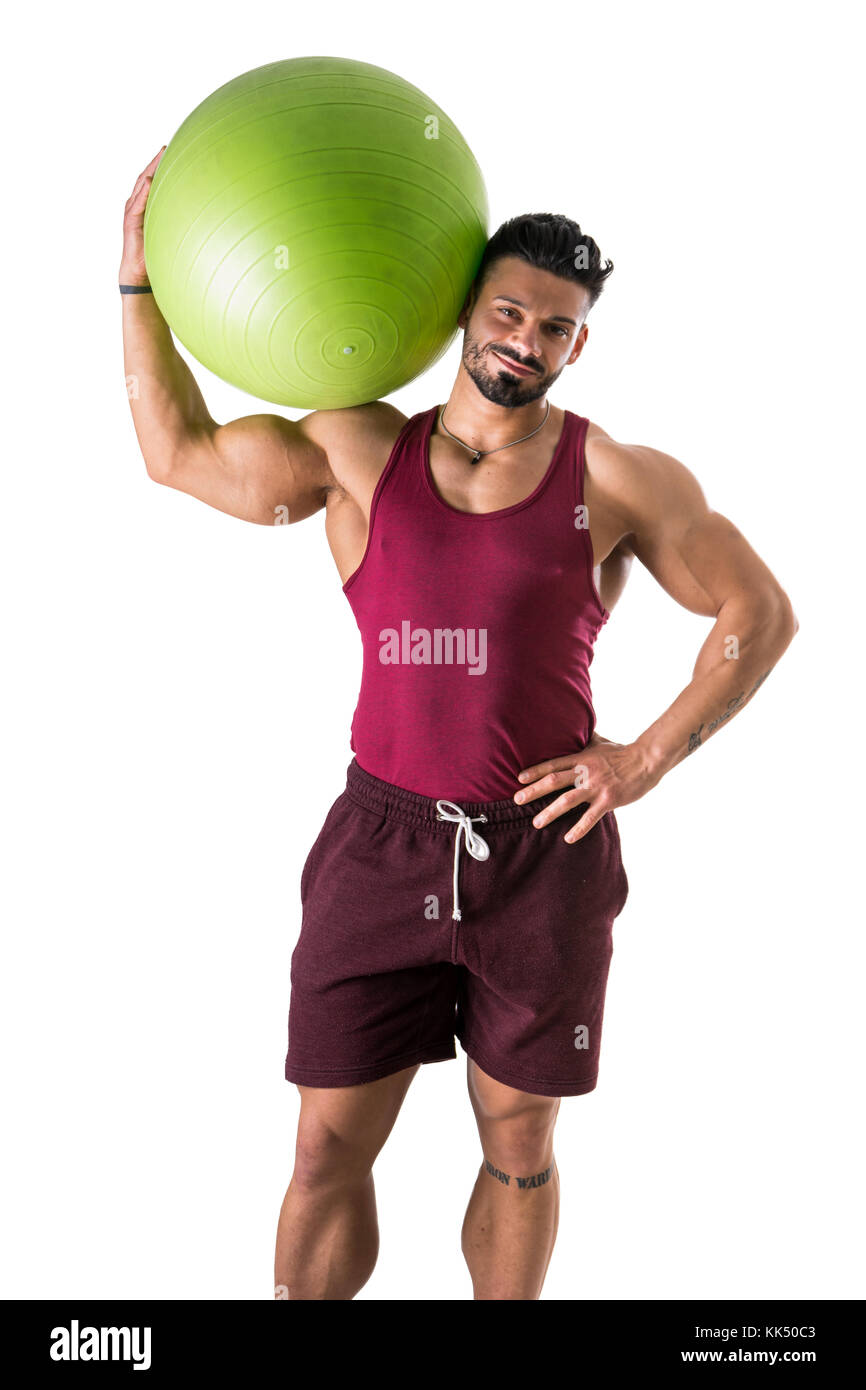 Muscular man holding inflatable fitness ball, looking at camera, comité permanent isolé sur fond blanc Banque D'Images