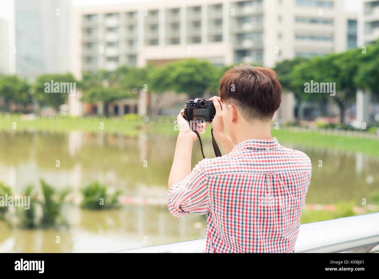 La moitié de la longueur de young asian man piscine dans la ville Prendre photo Banque D'Images