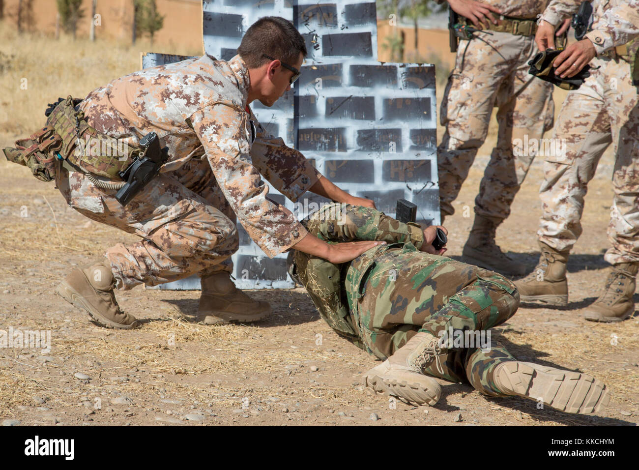 Un formateur de l'armée italienne affecté à la 3e Régiment alpin peshmergas aide un soldat avec rouler dans une position de tir au cours de formation au tir avancé au centre de coordination de la formation du Kurdistan près d'Erbil, Irak, 11 octobre 2017. L'KTCC est une combinaison d'un groupe de travail conjoint - Fonctionnement résoudre inhérent à renforcer les capacités des partenaires lieu consacre à la formation des forces des partenaires et renforcer leur efficacité sur le champ de bataille. Les GFIM-OIR est la Coalition mondiale pour vaincre ISIS en Iraq et en Syrie. (U.S. Photo de l'armée par le Sgt. Tracy McKithern) Banque D'Images