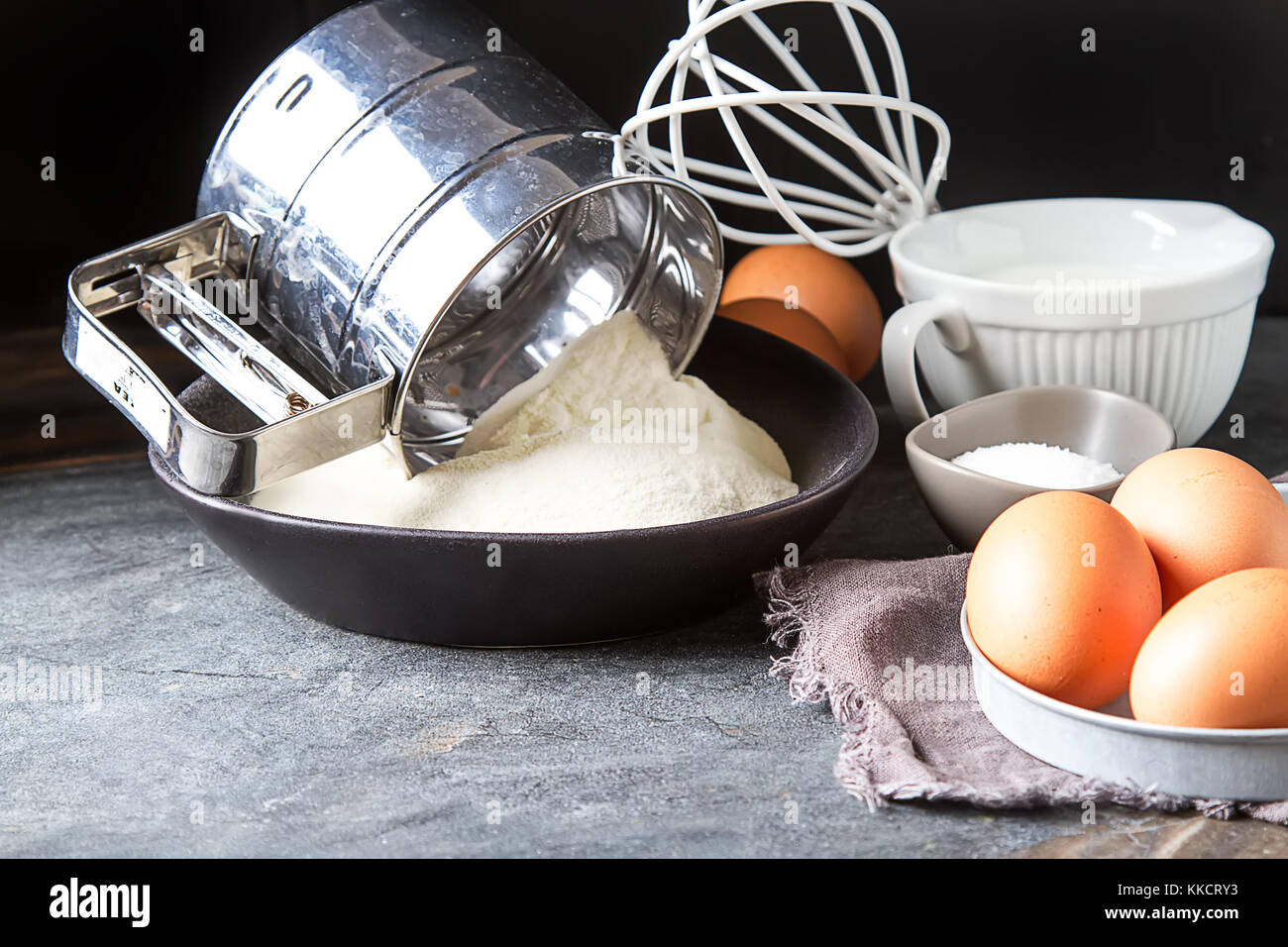 Ingrédients pour les crêpes, farine, lait, oeufs. traditionnel pour la Maslenitsa russe fond sombre. Banque D'Images