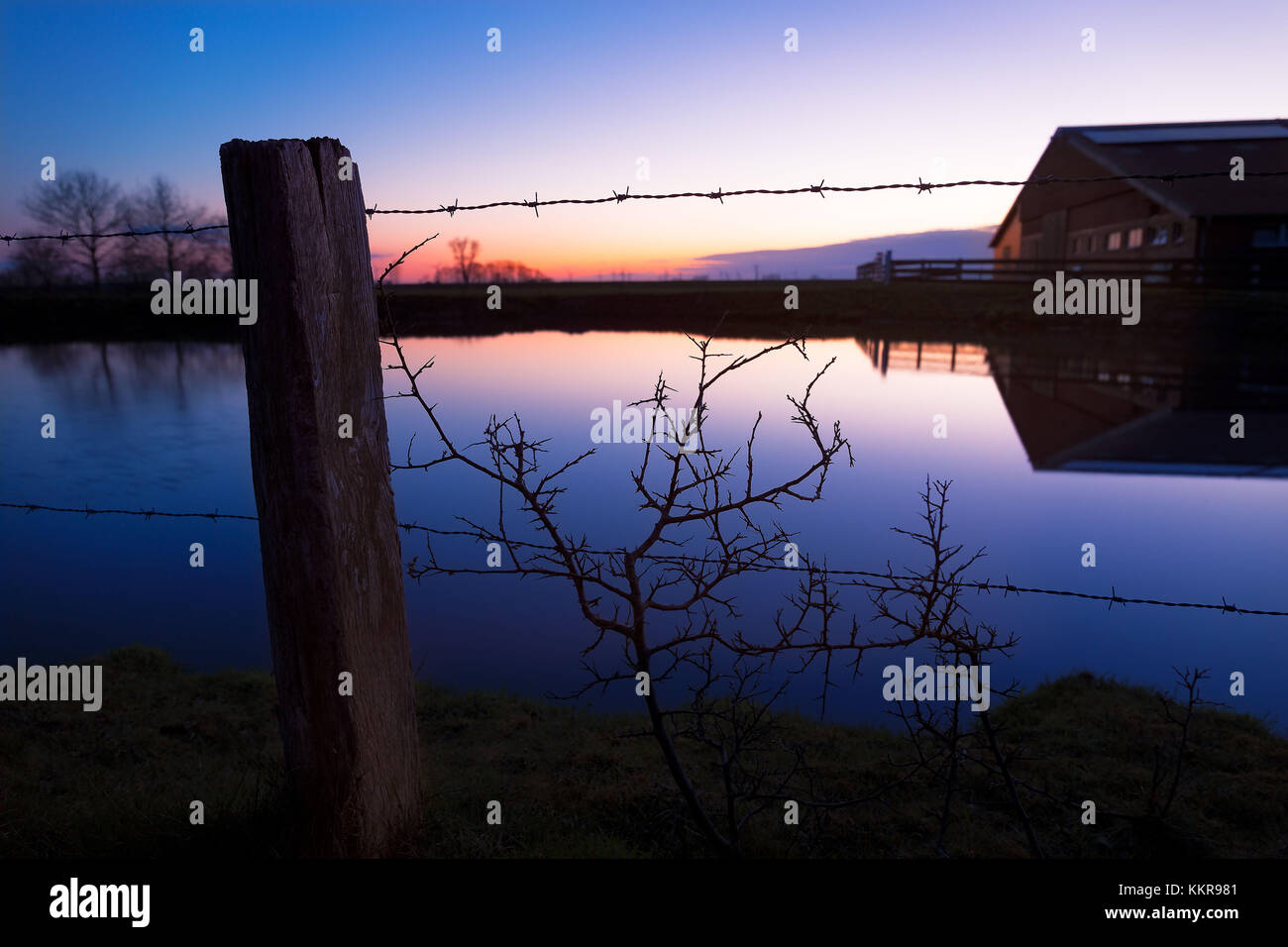 Une grange en Frise orientale au coucher du soleil Banque D'Images