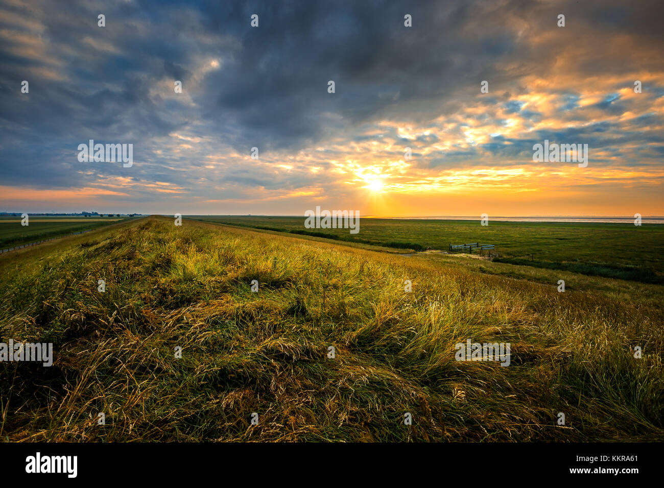 Coucher du soleil sur la digue près de ostbense sur un jour nuageux Banque D'Images