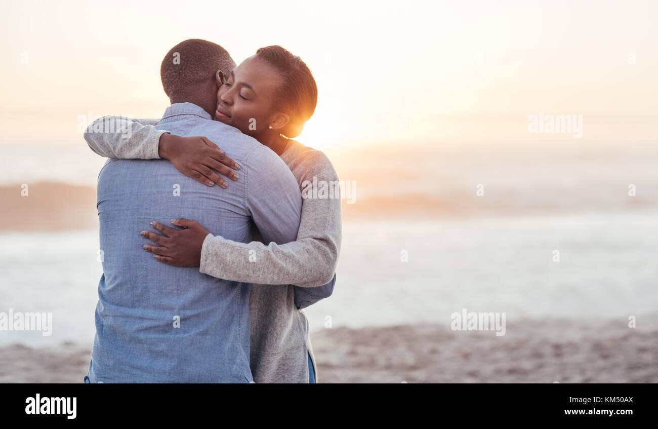 Content young African couple hugging at the beach Banque D'Images