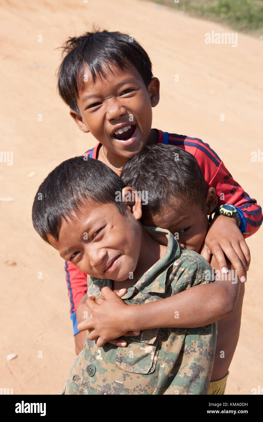 Trois garçons timides, Phumi Kouk Pouth sur le lac Tonlé Sap, Puok, Siem Reap, Cambodge Banque D'Images
