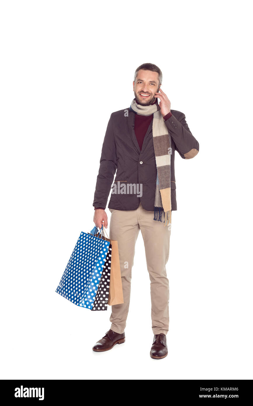 Man with shopping bags and smartphone Banque D'Images