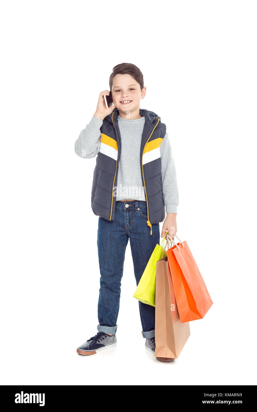 Boy with shopping bags and smartphone Banque D'Images