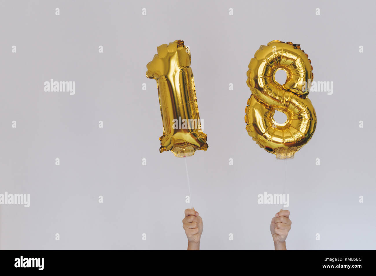 Hands holding golden 18 ballons, nouveau concept de l'année Banque D'Images