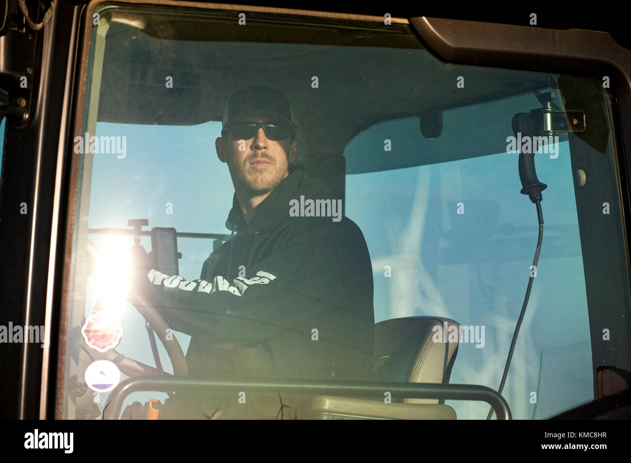 Agriculteur DANS LA CABINE DU TRACTEUR DE LA RÉCOLTE DE MAÏS DANS SA FERME PRÈS DE GRAND PRAIRIE, MINNESOTA Banque D'Images