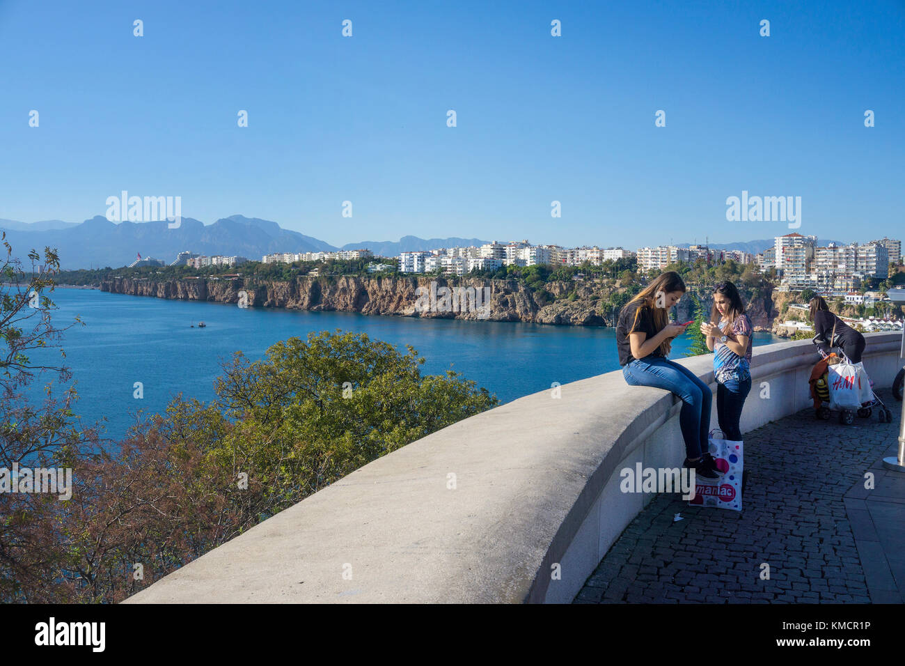 Les jeunes filles avec le smartphone à la promenade, le parc karaalioglu, vieille ville de Kaleici, Antalya, Turkish riviera, Turquie Banque D'Images