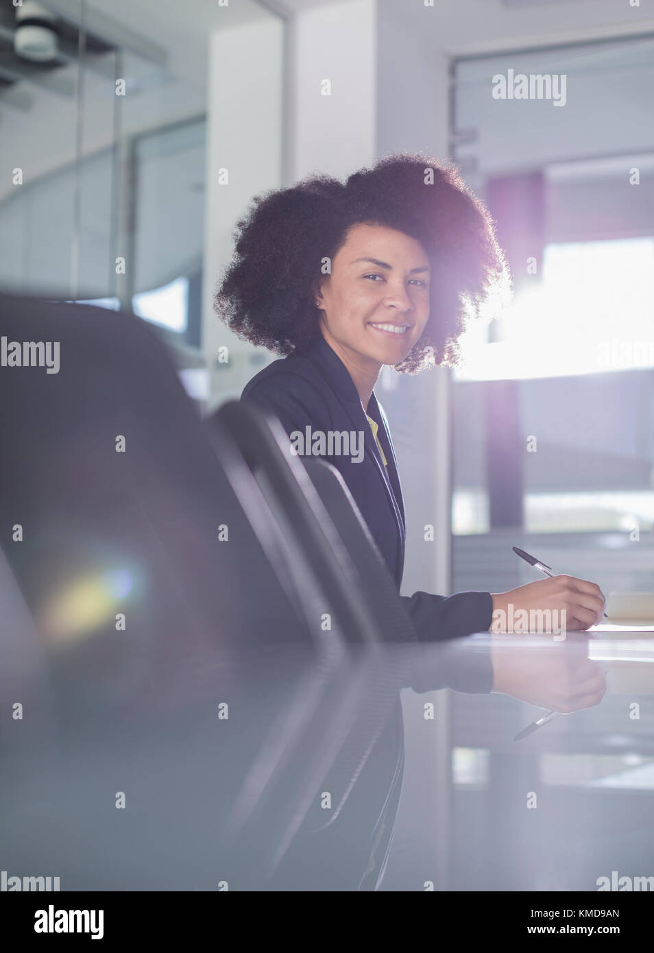 Portrait smiling businesswoman working in conference room Banque D'Images