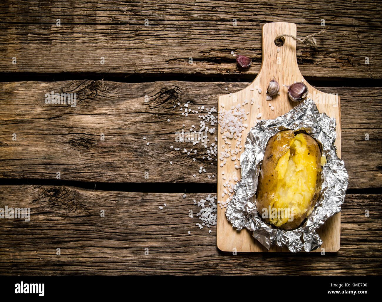 Les aliments de pommes de terre Pommes de terre au four dans du papier aluminium . sur une table