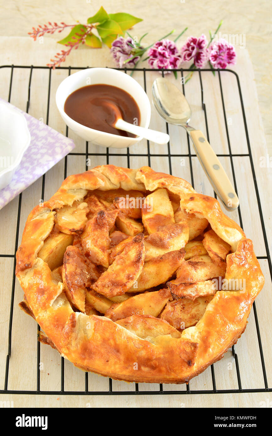 Galette de pomme frais cuit en croûte avec une sauce au caramel salé. Format vertical et tourné en lumière naturelle. Banque D'Images