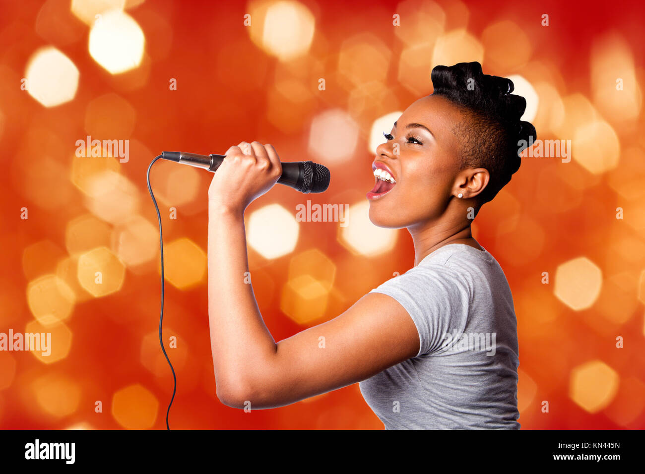 portrait de belle fille chantant avec microphone karaoké 16402139
