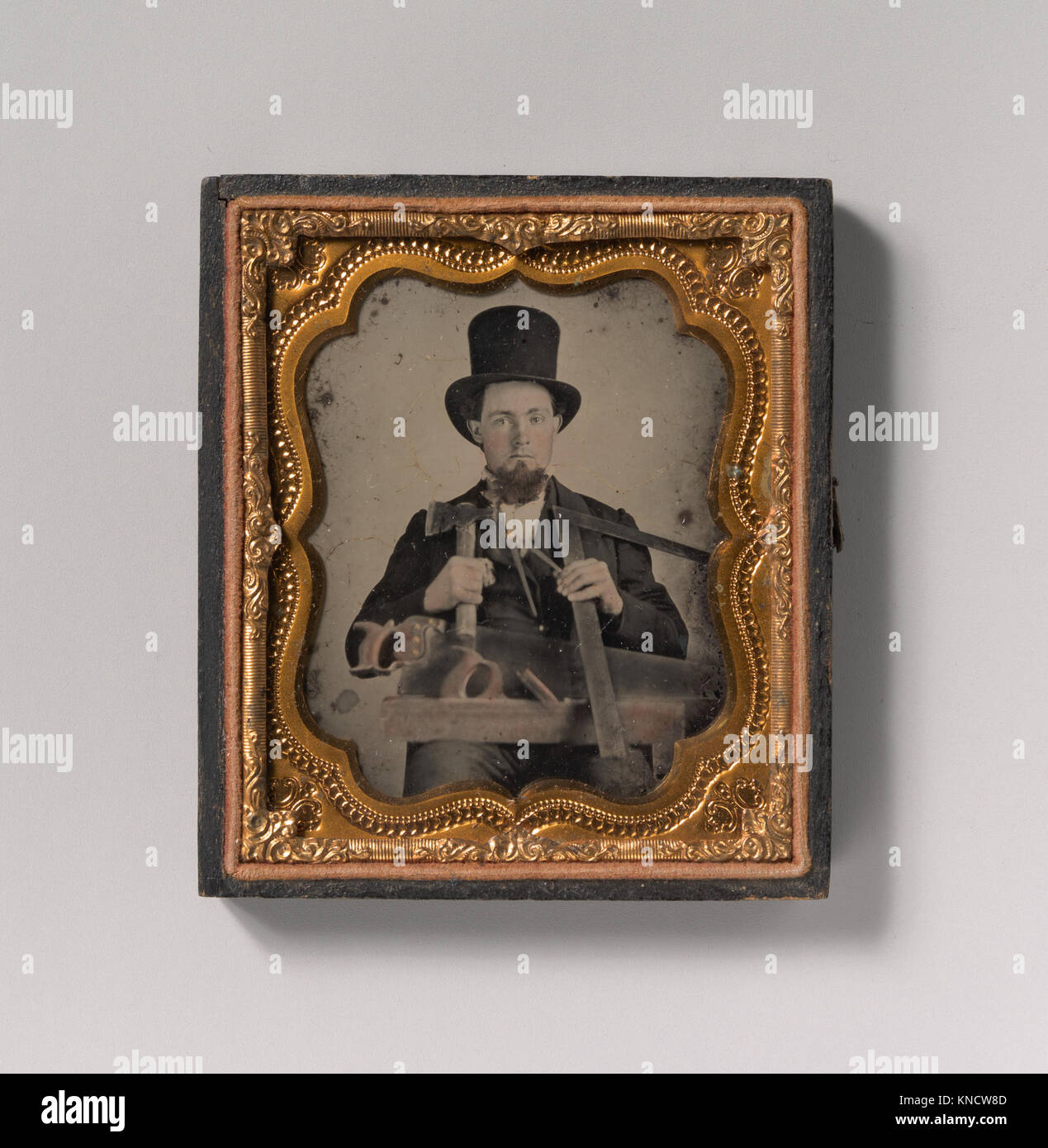 Cette représentation montre un menuisier portant un chapeau haut de gamme, utilisant des outils tels qu'une hachette, une boussole, un carré et une scie à main, illustrant l'artisanat manuel et les techniques de menuiserie du XIXe siècle. Banque D'Images