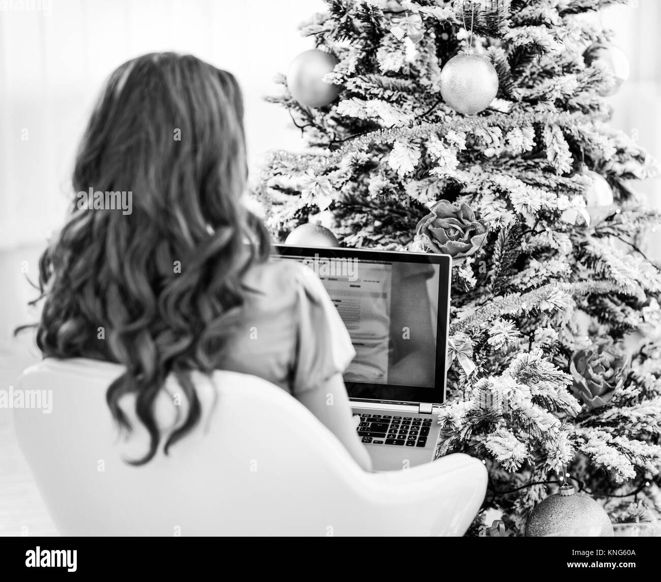 Woman near christmas tree . vue arrière Banque D'Images