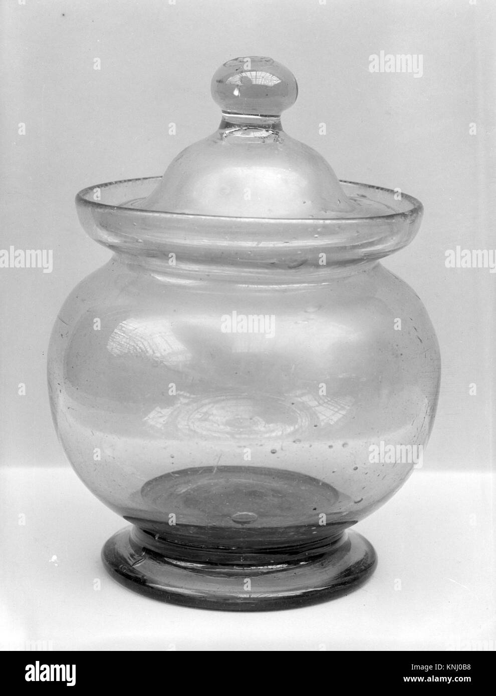 Un bol en verre couvert américain de 1800 à 1850, soufflé à volonté, mesurant 6 pouces de haut et 3,75 pouces de diamètre. L'objet reflète l'artisanat du verre américain et le design fonctionnel, qui font partie d'une collection de musée. Banque D'Images