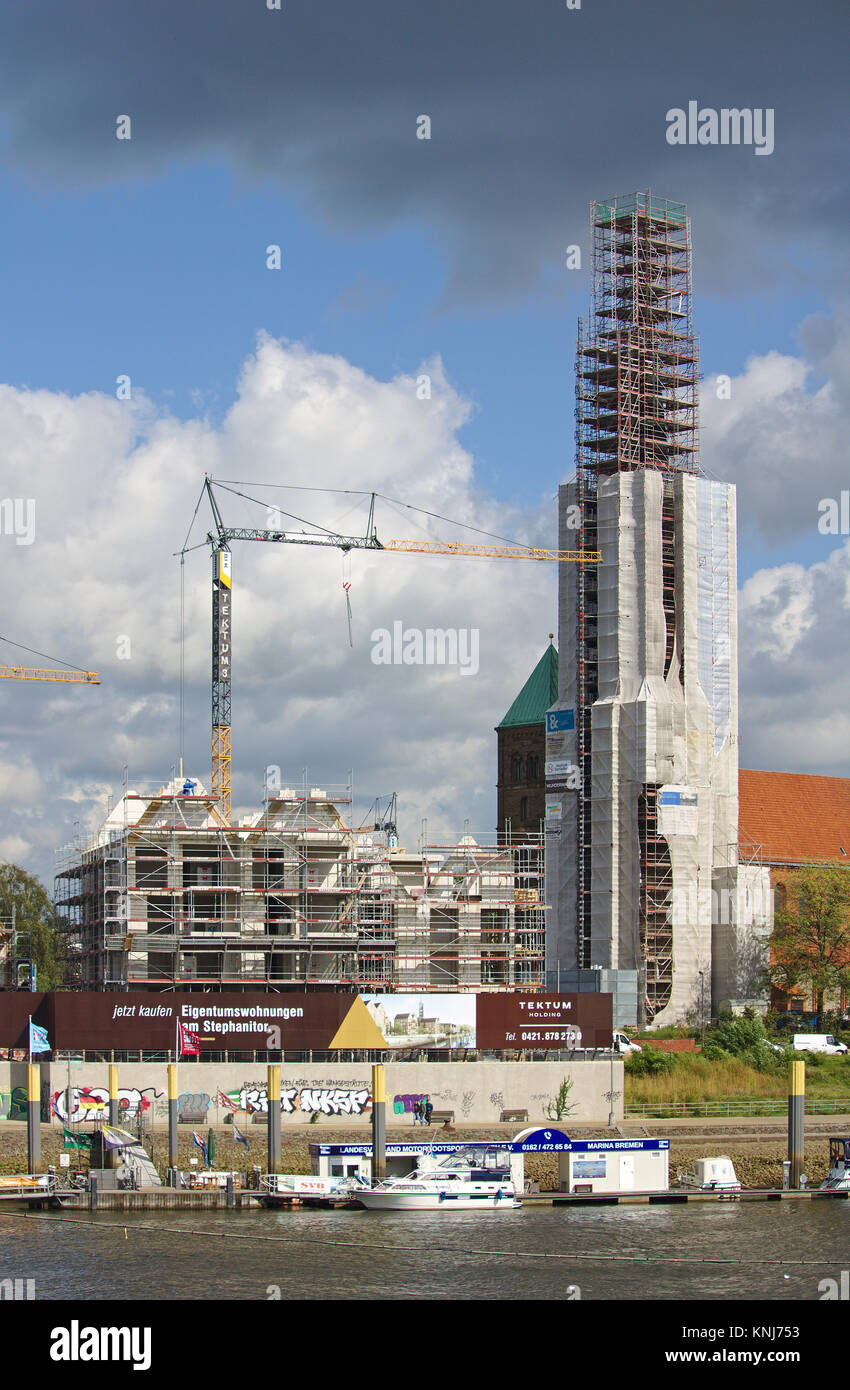 Bremen, Allemagne - Septembre 14th, 2017 Riverside - site de construction avec des grues, partiellement et entièrement achevé d'habitation, de l'église en vertu de recon Banque D'Images