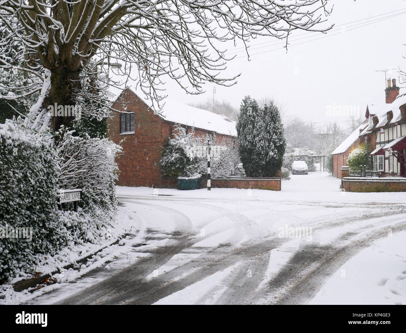 Une scène de village hivernal : traces dans la neige sur une ruelle tranquille en Angleterre Banque D'Images