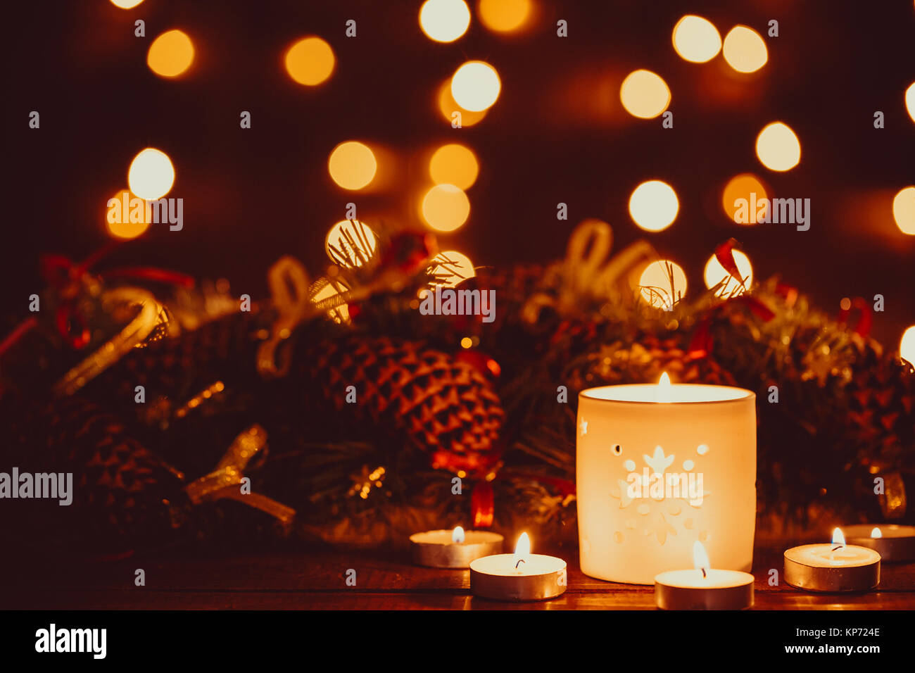 Noël lanterne avec brûler des bougies et de la guirlande sur vintage table en bois avec bokeh d'or. Espace libre Banque D'Images