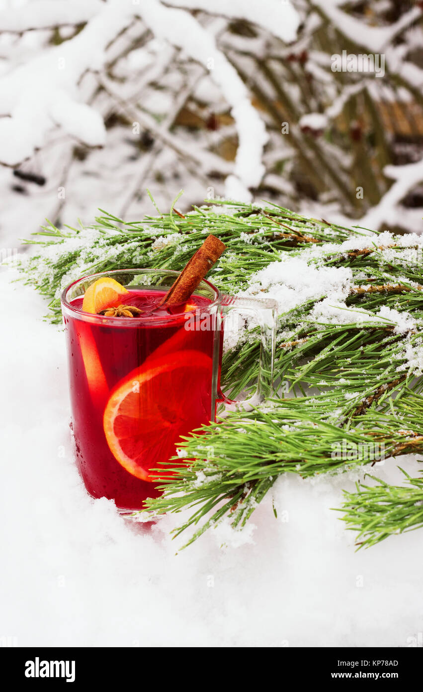 Vin chaud dans la rue dans la neige avec une branche de pin. Banque D'Images