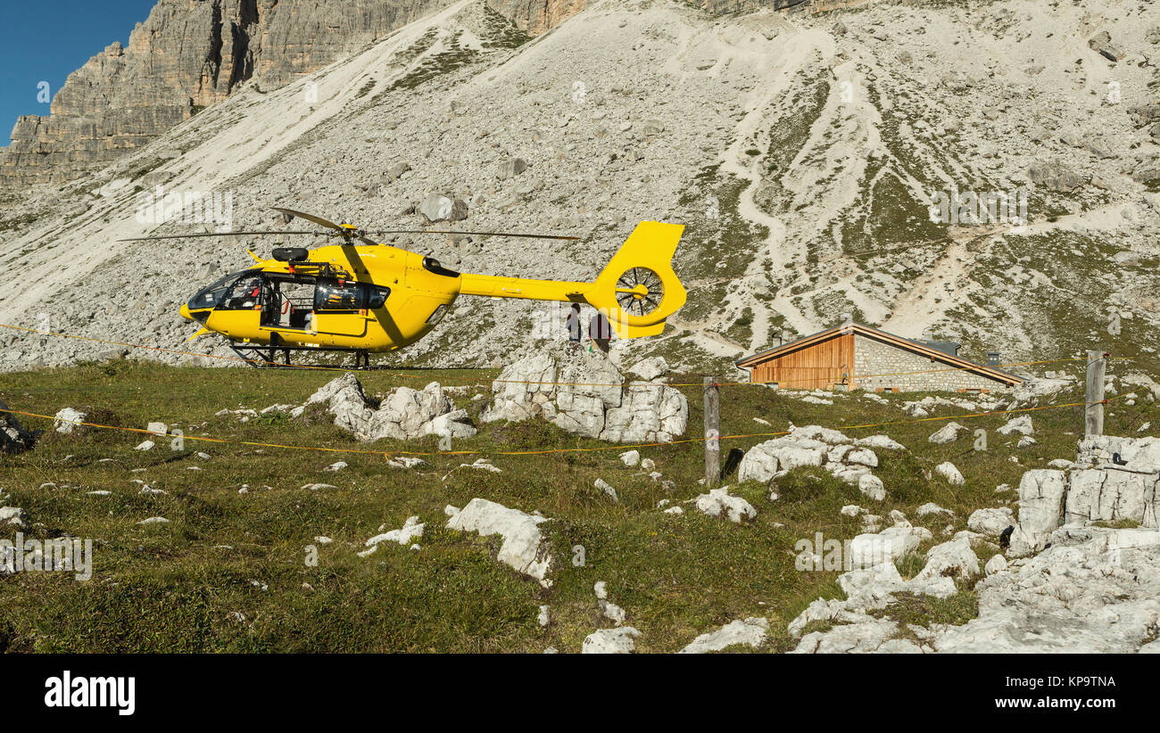 Hélicoptère jaune utilisé pour les opérations de sauvetage, sur le terrain en Dolomites, Italie. Sauvetage par hélicoptère Banque D'Images