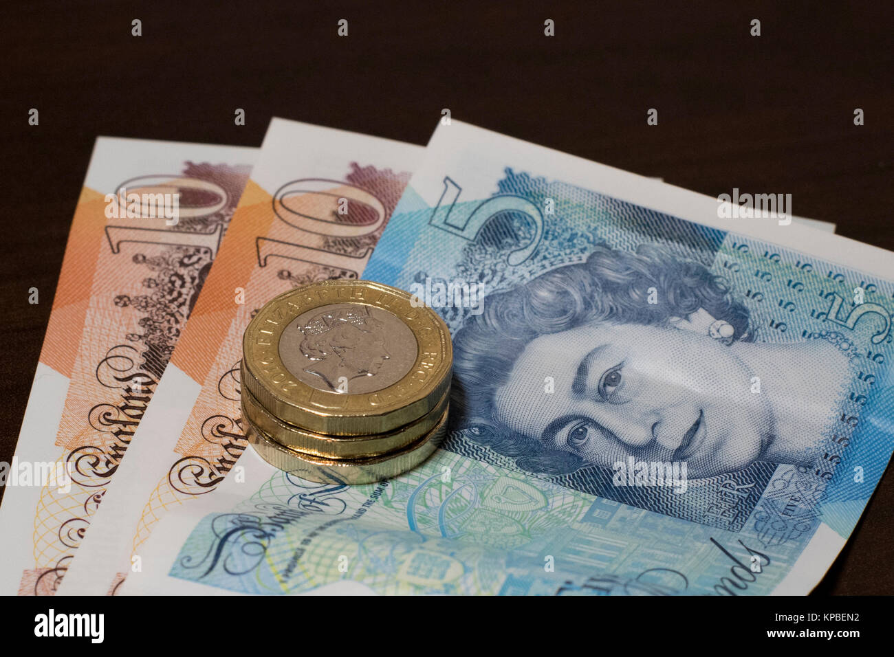 Beaucoup de livres sterling nouvelle série G des billets et pièces en euros. GBP 28 composé de deux billets de 10 livres, une note de cinq livres et de trois pièces de 1 €. Banque D'Images