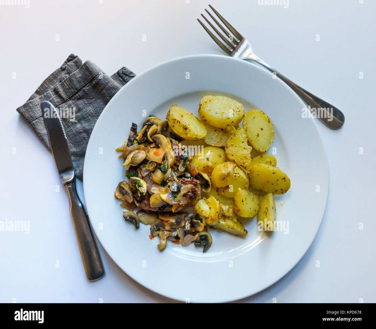 Steak haché avec une sauce à l'oignon et de champignons et pommes de terre sautées Banque D'Images