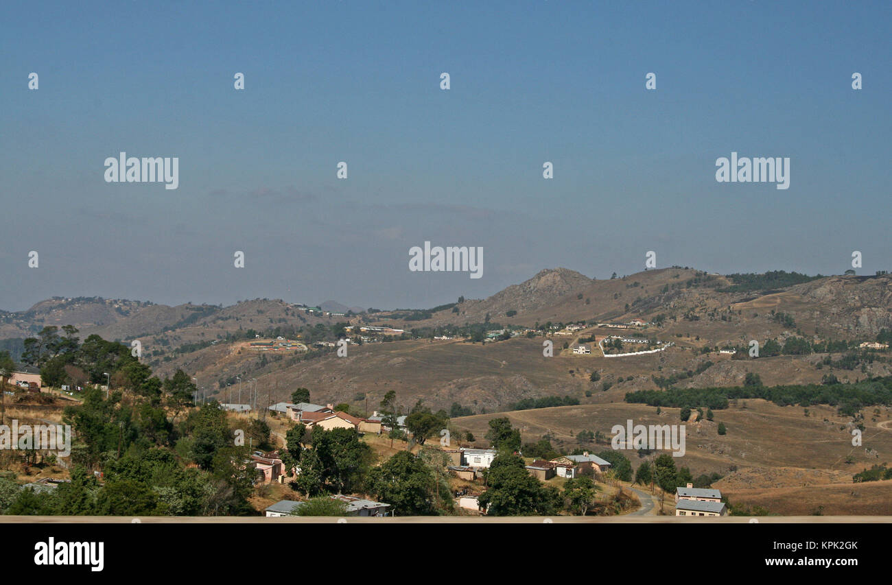 La colline au hasard, de maisons et d'arbres touffus, Royaume du Swaziland. Banque D'Images