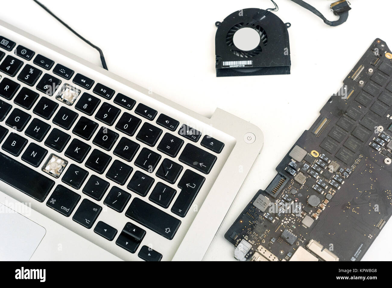 Composants cassés d'un macbook Apple ipad ordinateur sur un fond blanc avec un copyspace pour ordinateur idées de conception de réparation Banque D'Images